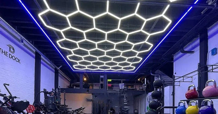 Hexagon light grid above a gym with kettlebells and training gear