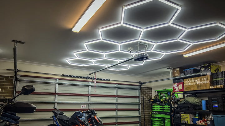 HexSpace 6500K daylight hexagon LED lighting installed across the ceiling of a real Australian residential garage with a motorbike and tool storage