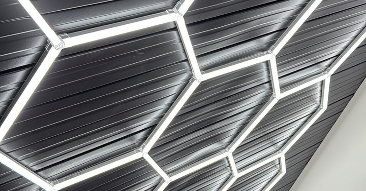 Hexagon light grid installed on a black corrugated ceiling