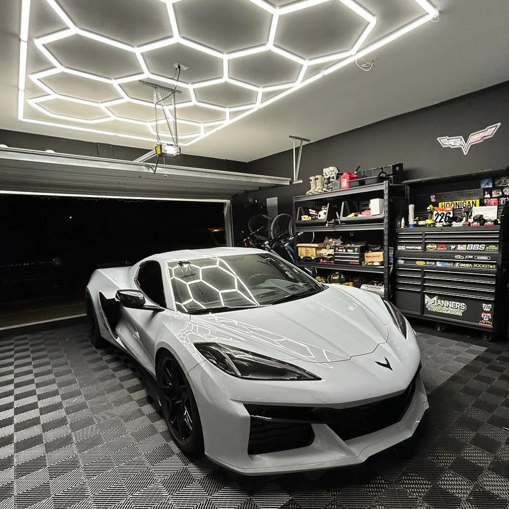 14 hexagon led lighting with border on white ceiling of black garage 