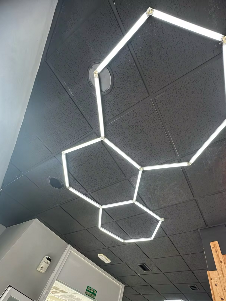 3 hexagonal lighting system on black ceiling 