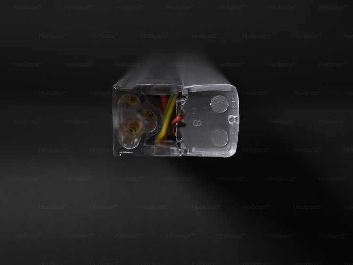 Close-up of transparent wiring connector with visible copper contacts for HexSpace hexagon LED lights
