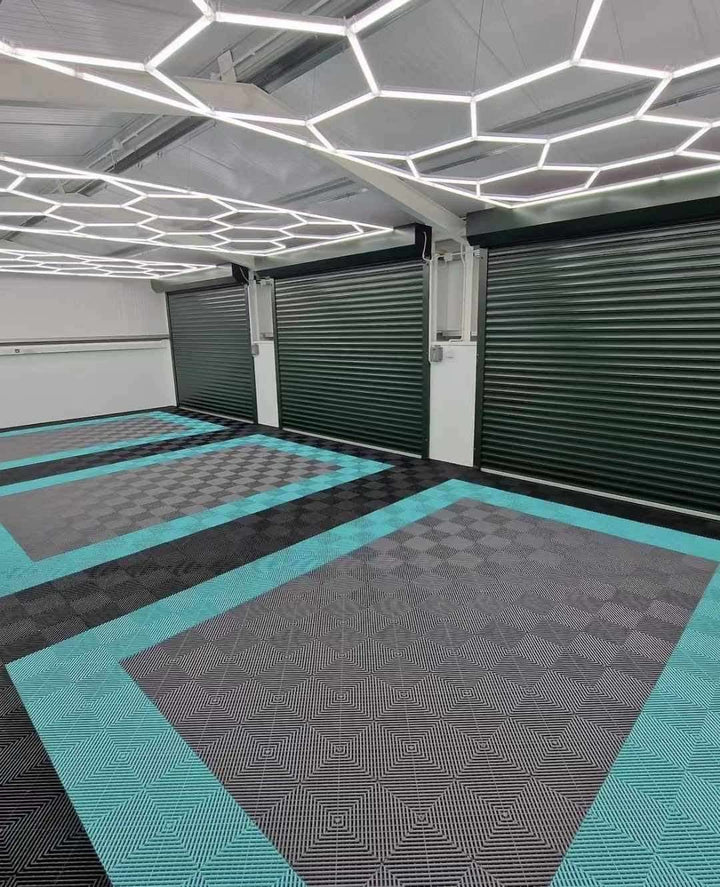 green grey and black flooring tiles in triple garage with hexagon light